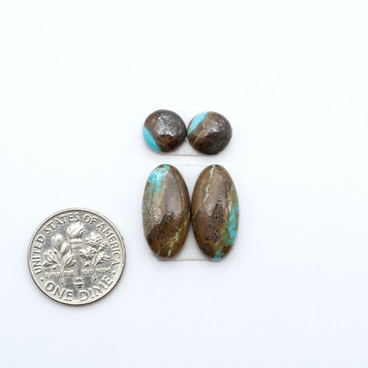 Number 8 Turquoise cabochons, blue and green color with brown matrix, polished stones on a white background, with a US dime for scale