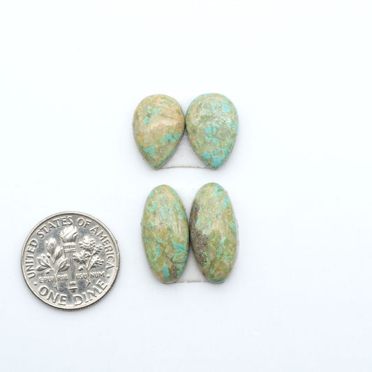 Number 8 Turquoise cabochons, blue and green color with brown matrix, polished stones on a white background, with a US dime for scale