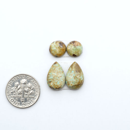 Number 8 Turquoise cabochons, blue and green color with brown matrix, polished stones on a white background, with a US dime for scale