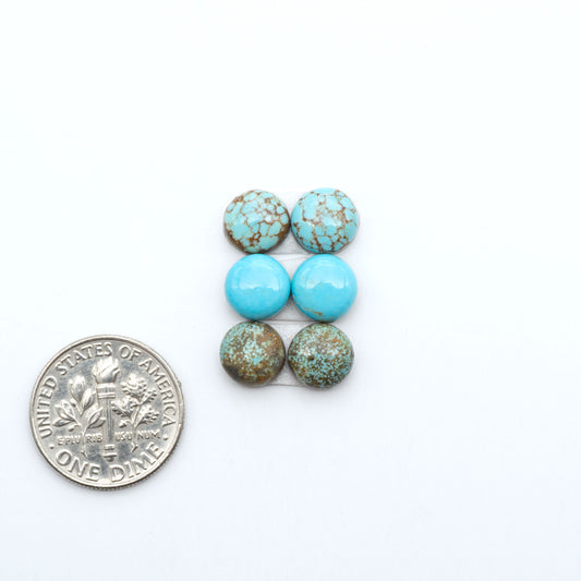 Number 8 Turquoise cabochons, blue and green color with brown matrix, polished stones on a white background, with a US dime for scale