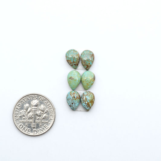 Number 8 Turquoise cabochons, blue and green color with brown matrix, polished stones on a white background, with a US dime for scale
