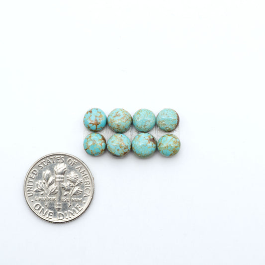 Number 8 Turquoise cabochons, blue and green color with brown matrix, polished stones on a white background, with a US dime for scale