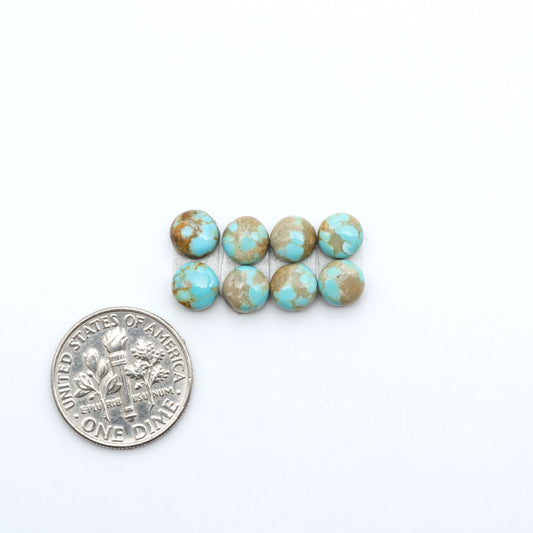 Number 8 Turquoise cabochons, blue and green color with brown matrix, polished stones on a white background, with a US dime for scale