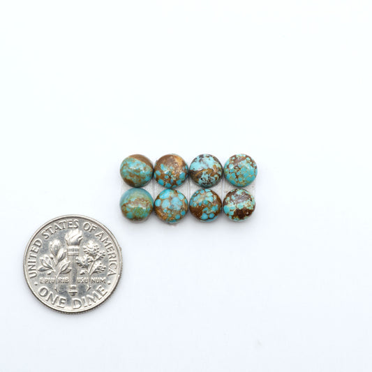 Number 8 Turquoise cabochons, blue and green color with brown matrix, polished stones on a white background, with a US dime for scale