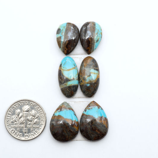 Number 8 Turquoise cabochons, blue and green color with brown matrix, polished stones on a white background, with a US dime for scale
