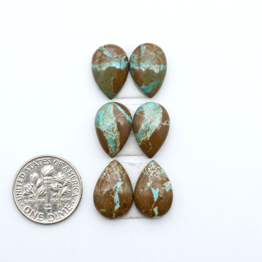 Number 8 Turquoise cabochons, blue and green color with brown matrix, polished stones on a white background, with a US dime for scale