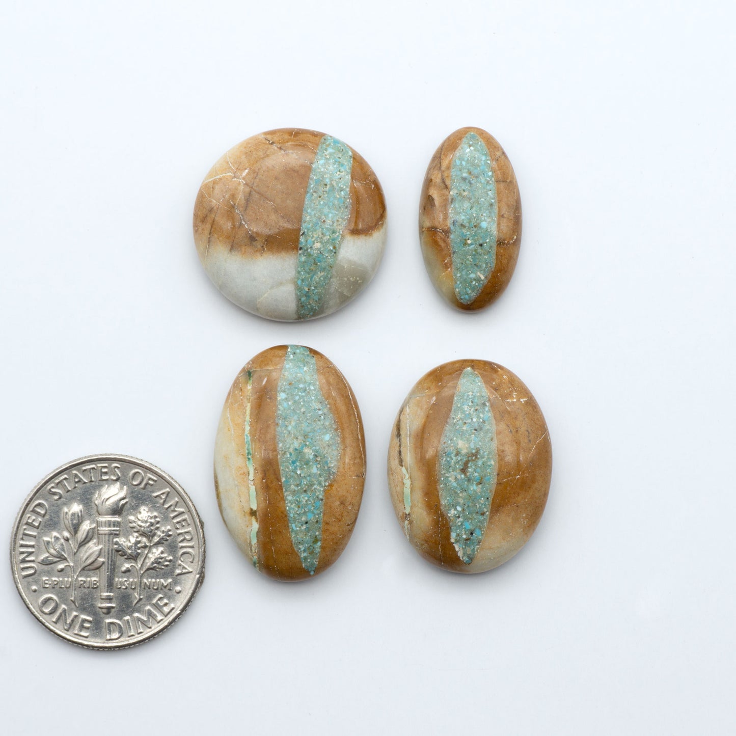 Royston Turquoise cabochons, blue-green color with natural matrix, polished stones on a white background, with a US dime for scale