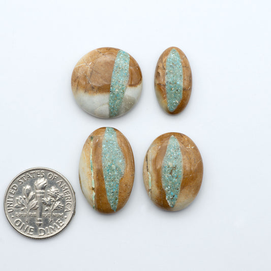Royston Turquoise cabochons, blue-green color with natural matrix, polished stones on a white background, with a US dime for scale