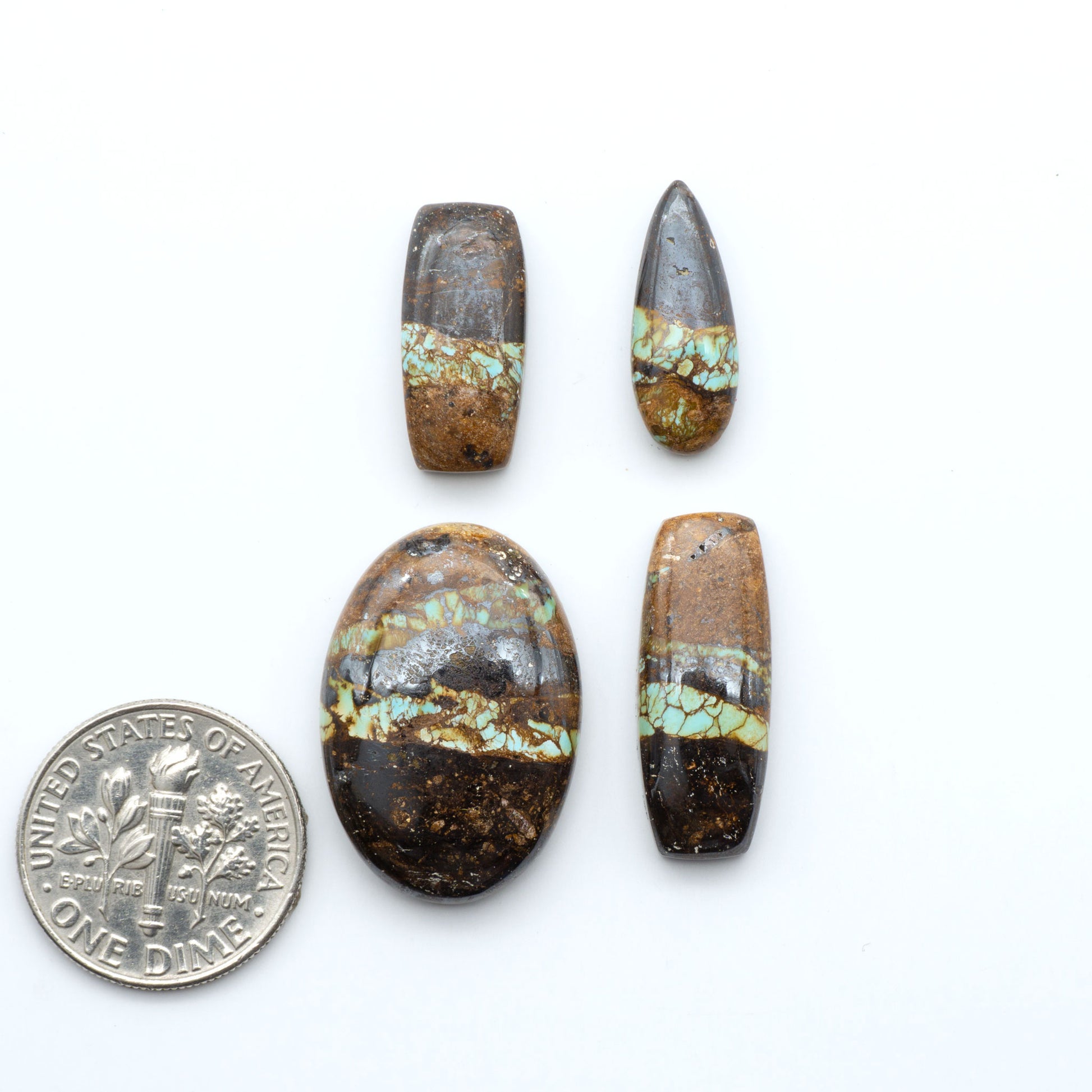 Royston Turquoise cabochons, blue-green color with natural matrix, polished stones on a white background, with a US dime for scale