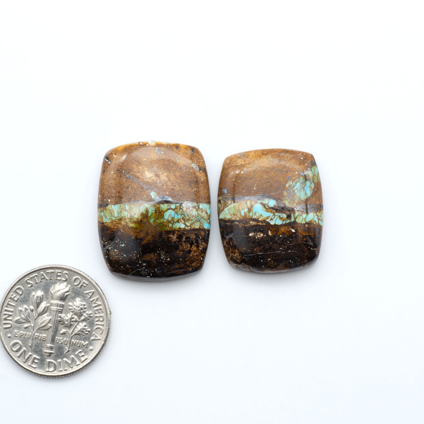 Royston Turquoise cabochons, blue-green color with natural matrix, polished stones on a white background, with a US dime for scale