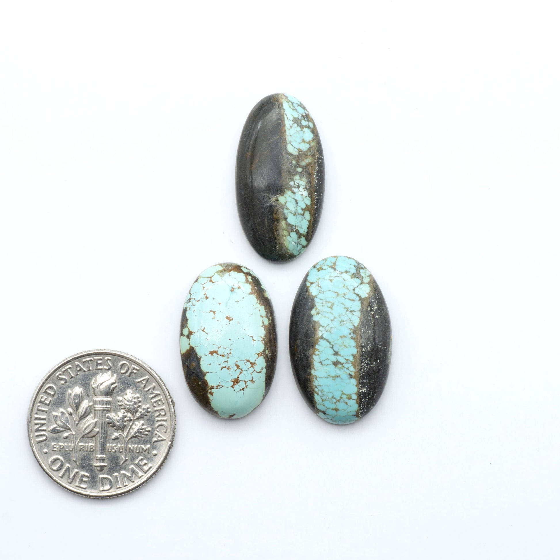 Number 8 Turquoise cabochons, blue and green color with brown matrix, polished stones on a white background, with a US dime for scale