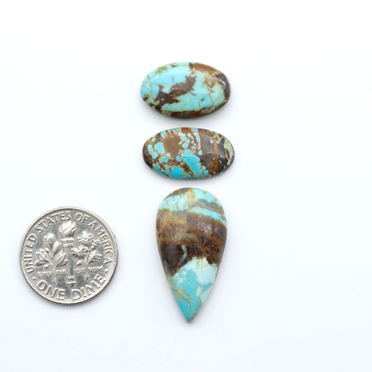 Number 8 Turquoise cabochons, blue and green color with brown matrix, polished stones on a white background, with a US dime for scale