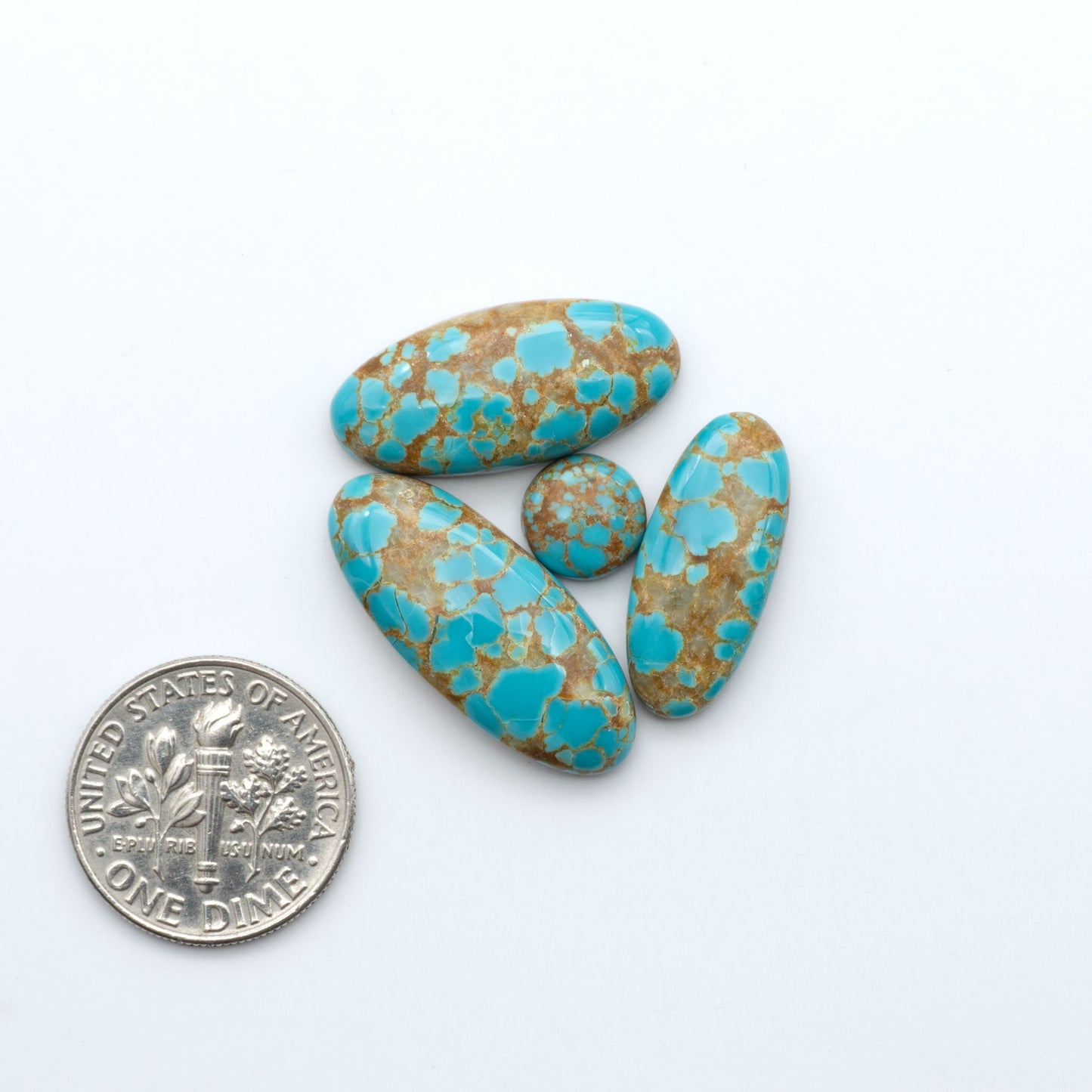 Number 8 Turquoise cabochons, blue and green color with brown matrix, polished stones on a white background, with a US dime for scale