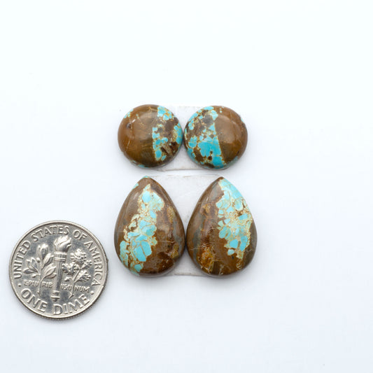 Number 8 Turquoise cabochons, blue and green color with brown matrix, polished stones on a white background, with a US dime for scale
