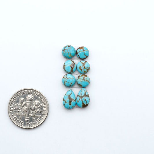 Number 8 Turquoise cabochons, blue and green color with brown matrix, polished stones on a white background, with a US dime for scale