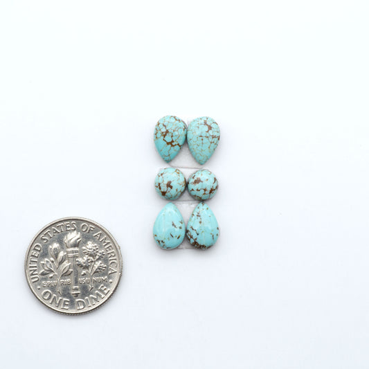 Number 8 Turquoise cabochons, blue and green color with brown matrix, polished stones on a white background, with a US dime for scale