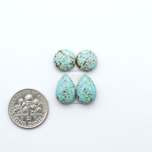 Number 8 Turquoise cabochons, blue and green color with brown matrix, polished stones on a white background, with a US dime for scale