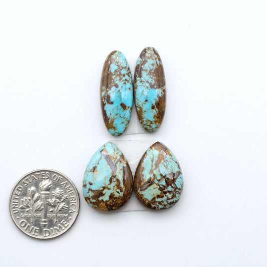 Number 8 Turquoise cabochons, blue and green color with brown matrix, polished stones on a white background, with a US dime for scale