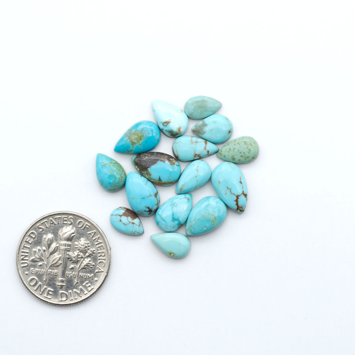 Number 8 Turquoise cabochons, blue and green color with brown matrix, polished stones on a white background, with a US dime for scale