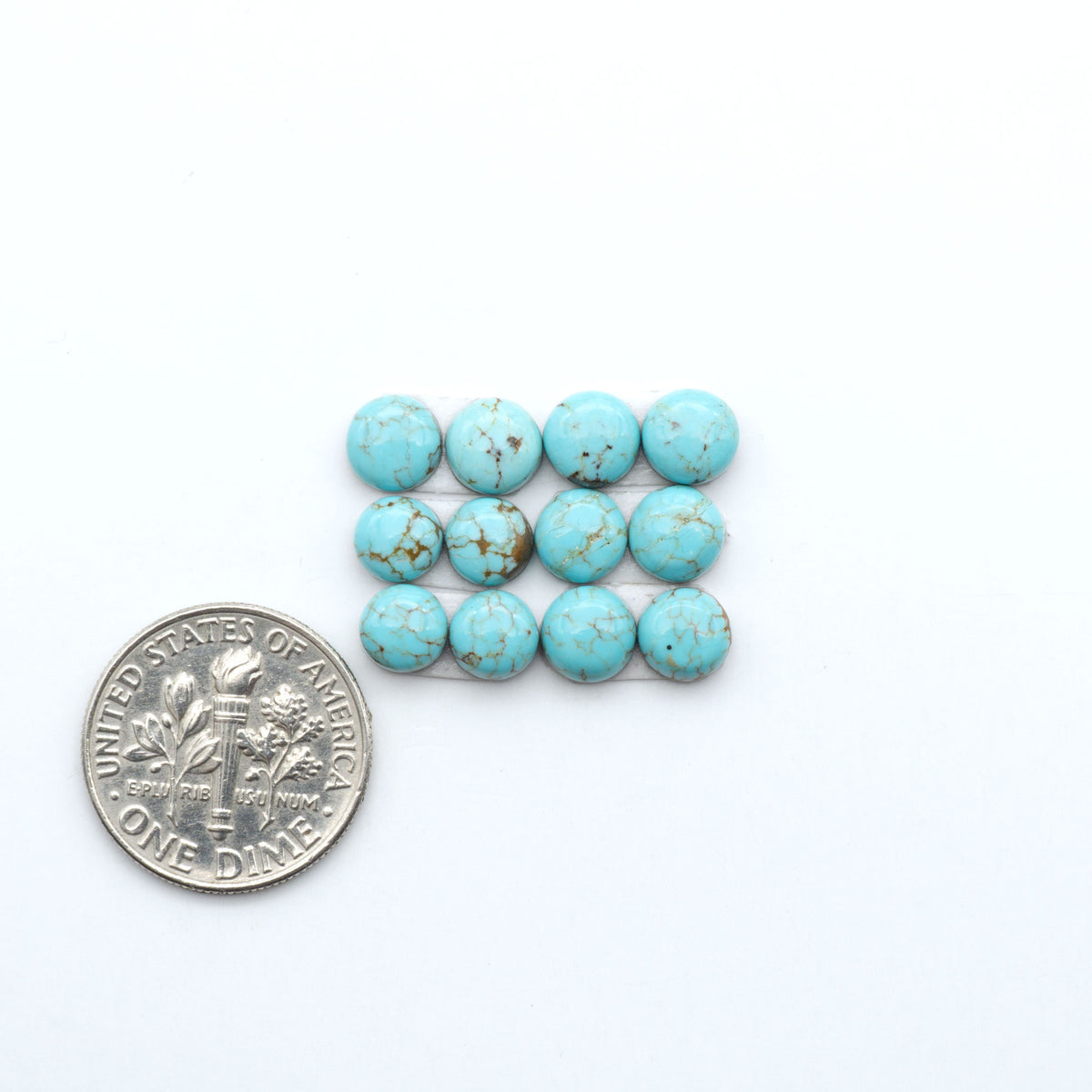 Number 8 Turquoise cabochons, blue and green color with brown matrix, polished stones on a white background, with a US dime for scale