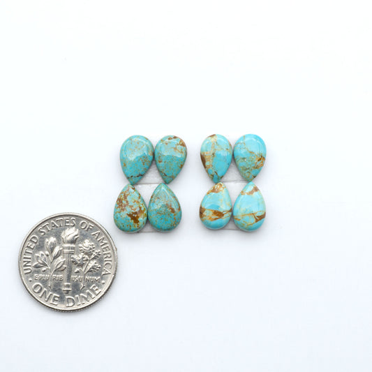 Number 8 Turquoise cabochons, blue and green color with brown matrix, polished stones on a white background, with a US dime for scale