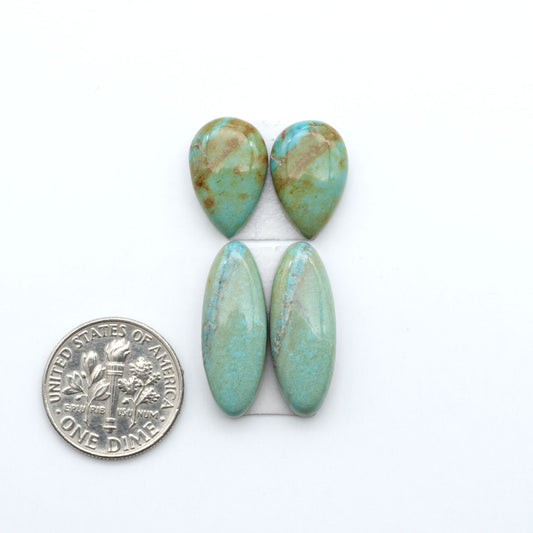 Number 8 Turquoise cabochons, blue and green color with brown matrix, polished stones on a white background, with a US dime for scale