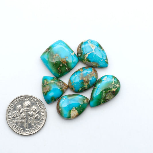 Sonoran Mountain Turquoise cabochons, blue-green color with natural matrix, polished stones on a white background, with a US dime for scale