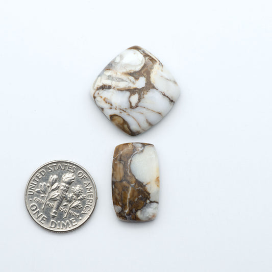 Wild Horse Magnesite cabochons, white gemstones with brown matrix on a white background, with a US dime for scale