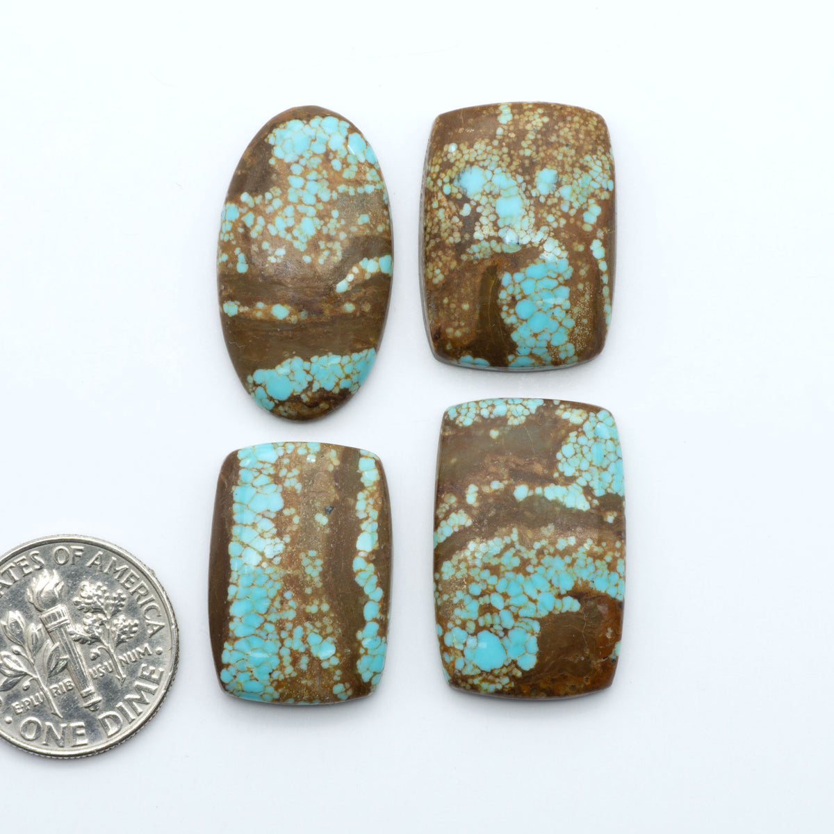 Number 8 Turquoise cabochons, blue and green color with brown matrix, polished stones on a white background, with a US dime for scale