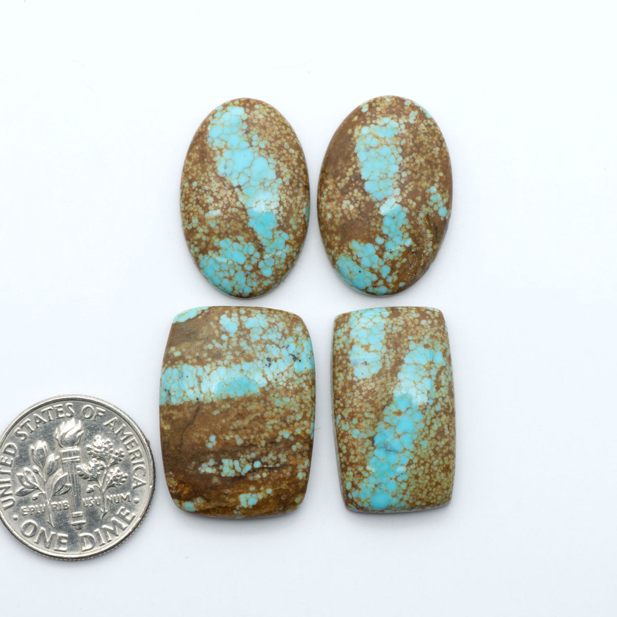 Number 8 Turquoise cabochons, blue and green color with brown matrix, polished stones on a white background, with a US dime for scale