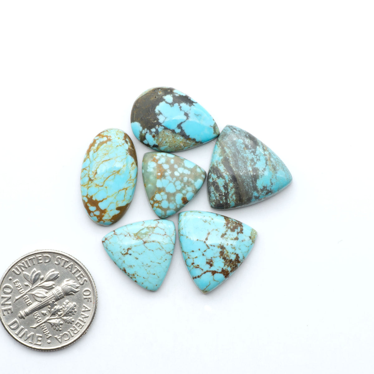 Number 8 Turquoise cabochons, blue and green color with brown matrix, polished stones on a white background, with a US dime for scale