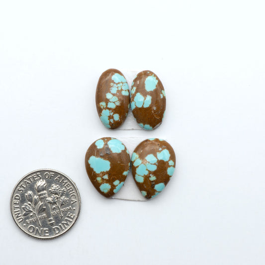 Number 8 Turquoise cabochons, blue and green color with brown matrix, polished stones on a white background, with a US dime for scale