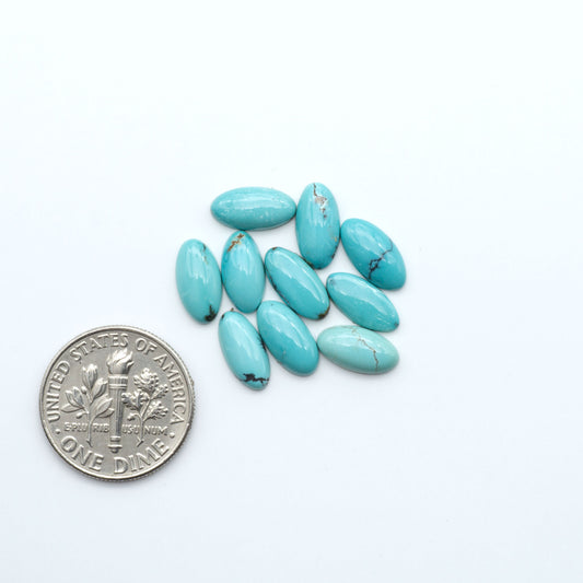 Hubei Cloud Mountain Turquoise cabochons, blue and green color with black matrix, polished stones on a white background, with a US dime for scale