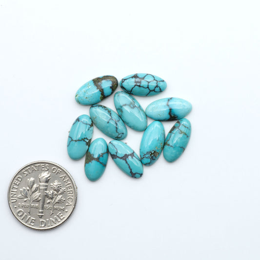 Hubei Cloud Mountain Turquoise cabochons, blue and green color with black matrix, polished stones on a white background, with a US dime for scale