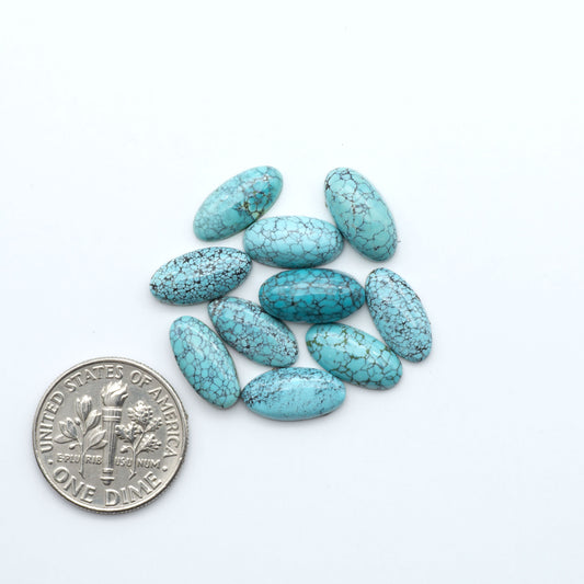 Hubei Cloud Mountain Turquoise cabochons, blue and green color with black matrix, polished stones on a white background, with a US dime for scale