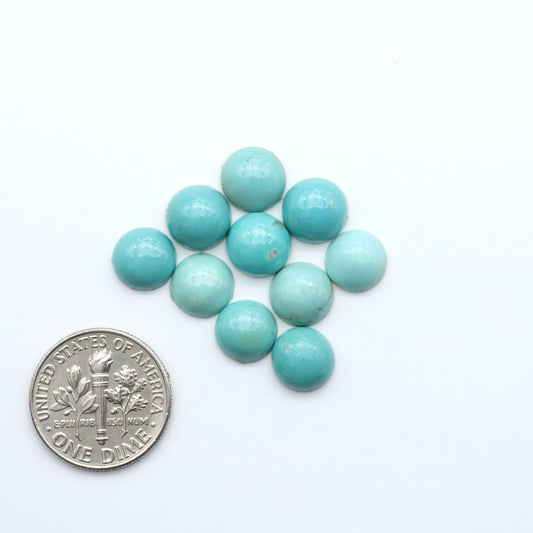 Hubei Cloud Mountain Turquoise cabochons, blue and green color with black matrix, polished stones on a white background, with a US dime for scale