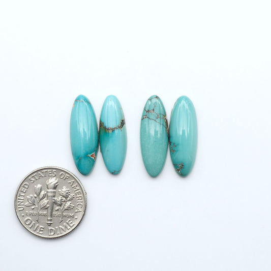 Hubei Cloud Mountain Turquoise cabochons, blue and green color with black matrix, polished stones on a white background, with a US dime for scale