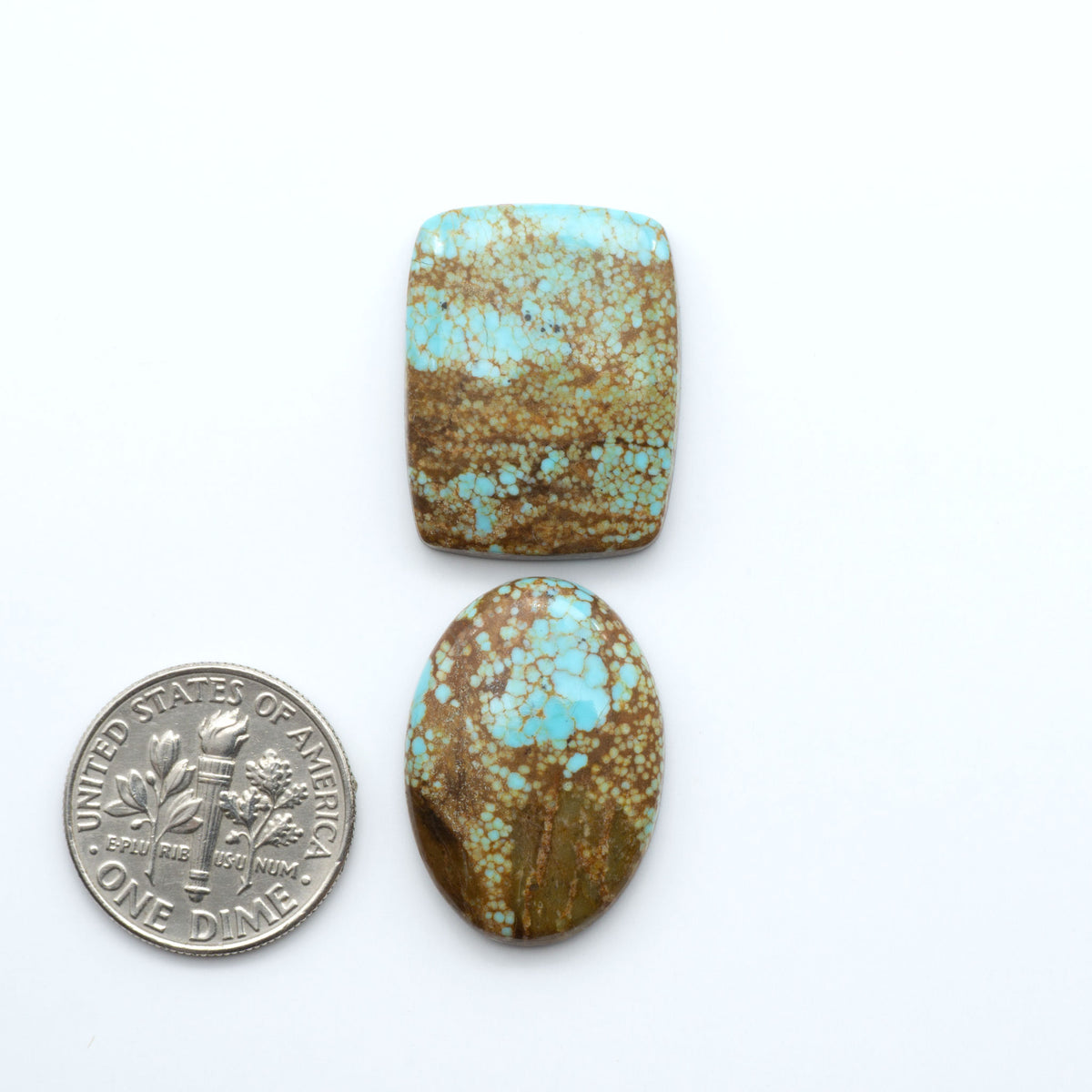Number 8 Turquoise cabochons, blue and green color with brown matrix, polished stones on a white background, with a US dime for scale