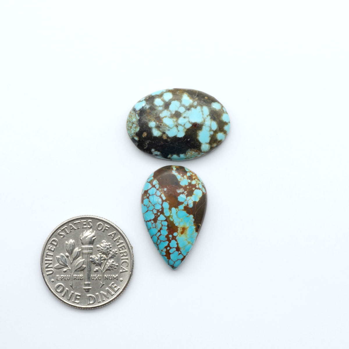 Number 8 Turquoise cabochons, blue and green color with brown matrix, polished stones on a white background, with a US dime for scale
