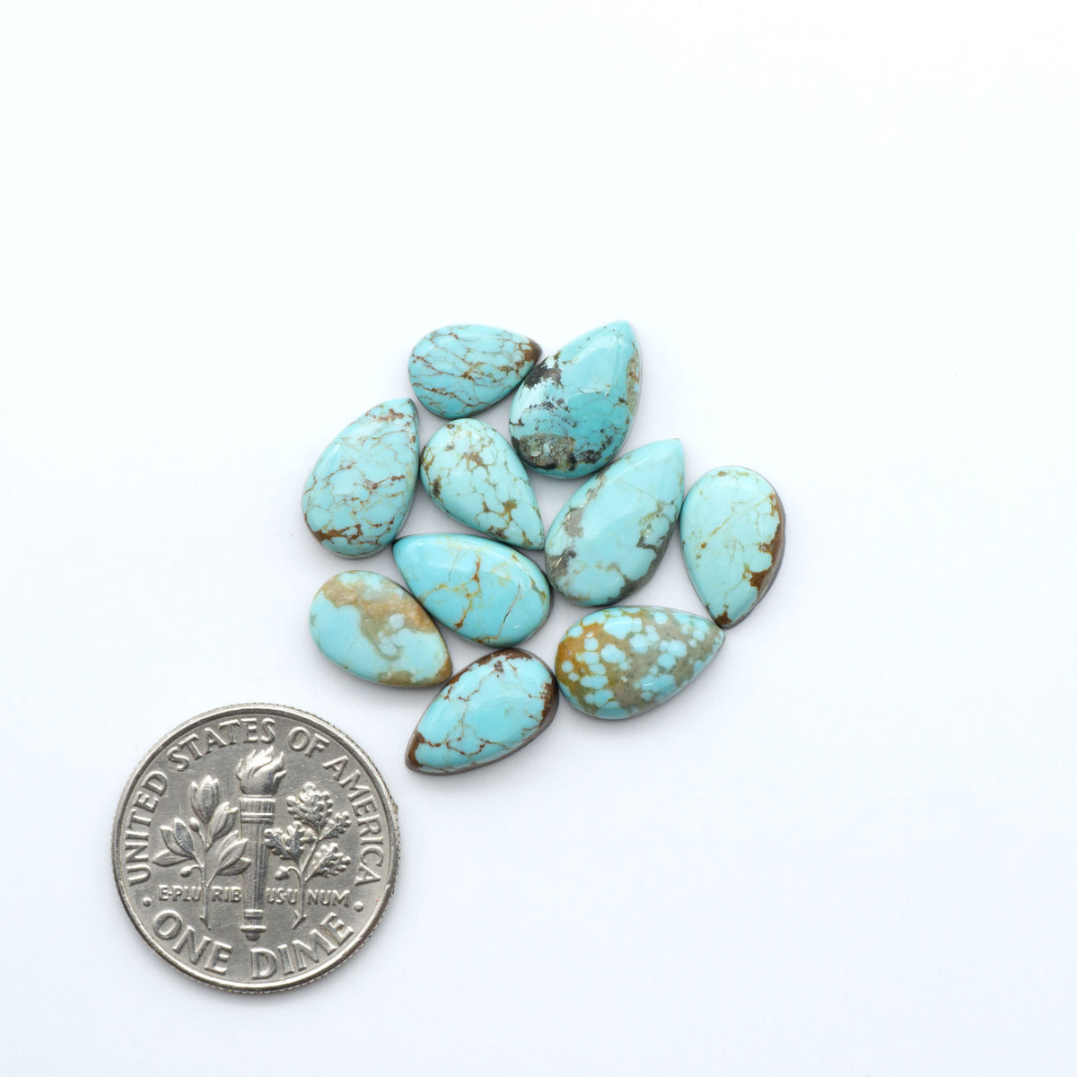 Number 8 Turquoise cabochons, blue and green color with brown matrix, polished stones on a white background, with a US dime for scale