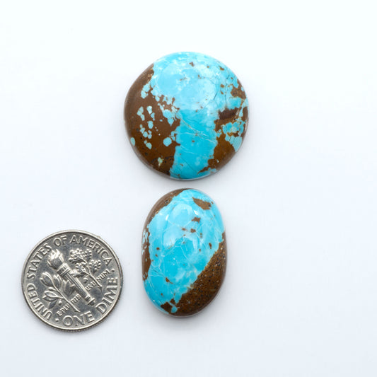 Number 8 Turquoise cabochons, blue and green color with brown matrix, polished stones on a white background, with a US dime for scale