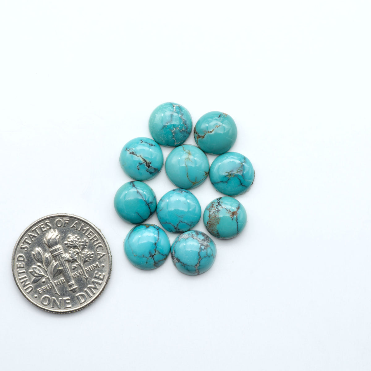Hubei Cloud Mountain Turquoise cabochons, blue and green color with black matrix, polished stones on a white background, with a US dime for scale