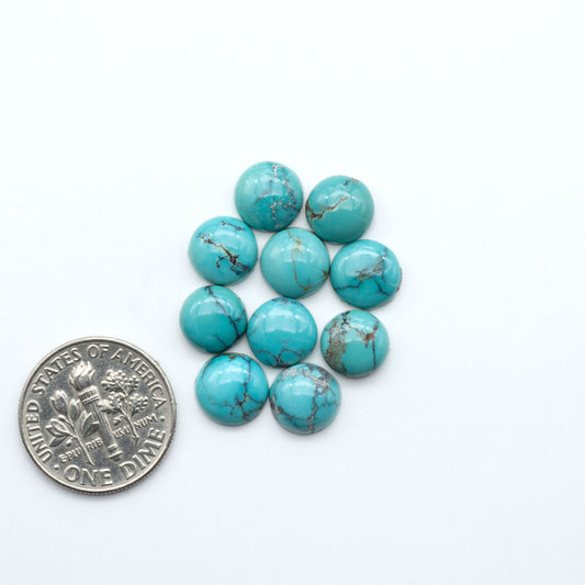 Hubei Cloud Mountain Turquoise cabochons, blue and green color with black matrix, polished stones on a white background, with a US dime for scale