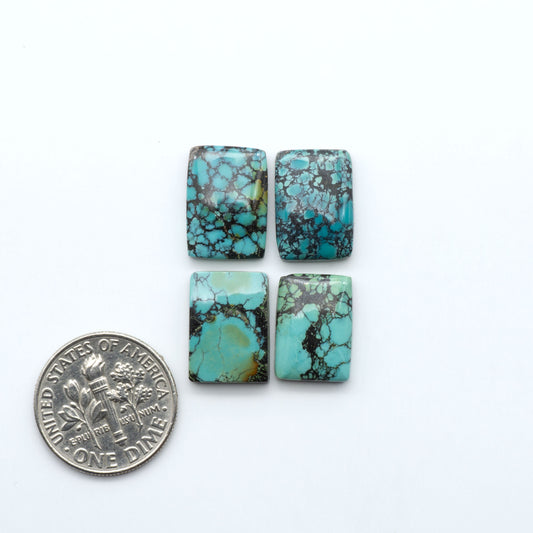 Hubei Cloud Mountain Turquoise cabochons, blue and green color with black matrix, polished stones on a white background, with a US dime for scale