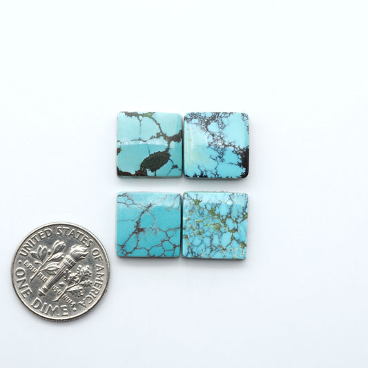 Hubei Cloud Mountain Turquoise cabochons, blue and green color with black matrix, polished stones on a white background, with a US dime for scale