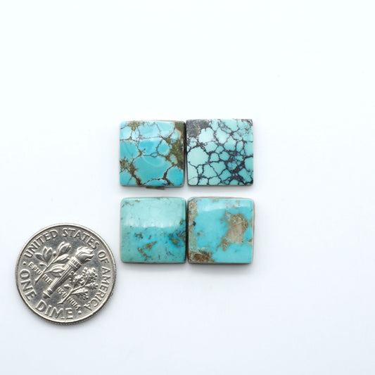 Hubei Cloud Mountain Turquoise cabochons, blue and green color with black matrix, polished stones on a white background, with a US dime for scale