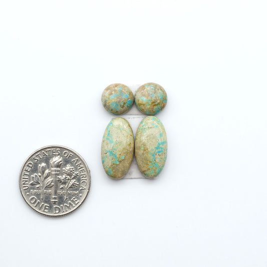 Number 8 Turquoise cabochons, blue and green color with brown matrix, polished stones on a white background, with a US dime for scale