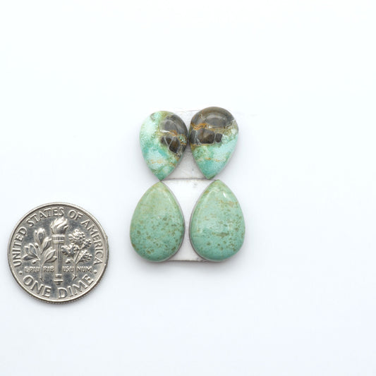 Number 8 Turquoise cabochons, blue and green color with brown matrix, polished stones on a white background, with a US dime for scale