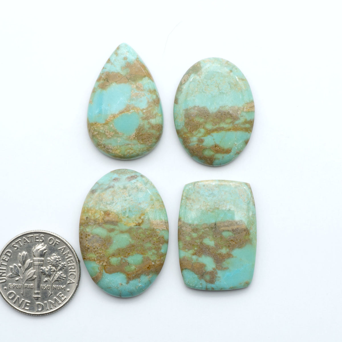 Number 8 Turquoise cabochons, blue and green color with brown matrix, polished stones on a white background, with a US dime for scale